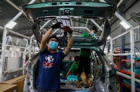 Wiring work at the rear hatch on the assembly line
