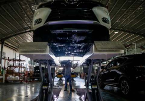 Vehicle on lift during assembly inspection